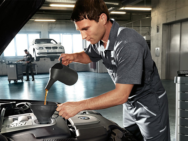 Service tech performing a BMW oil change