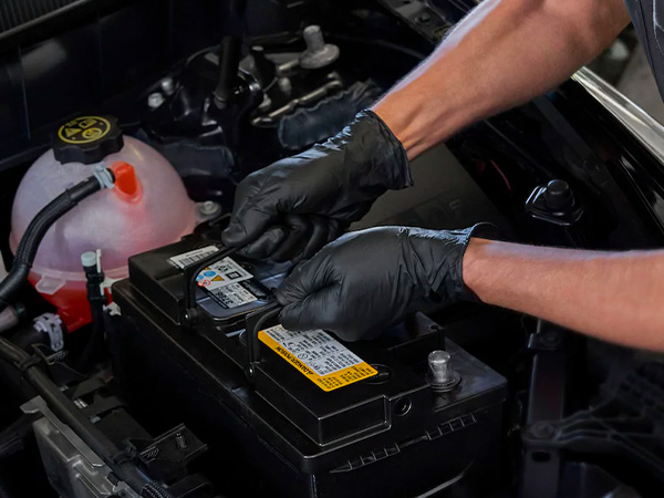Service tech testing a battery