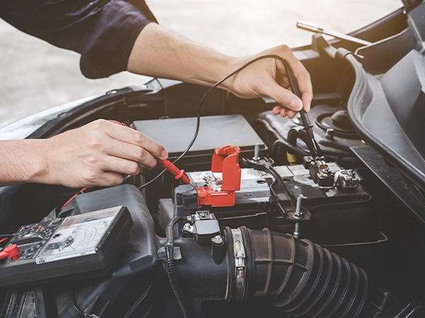 Service tech testing a battery