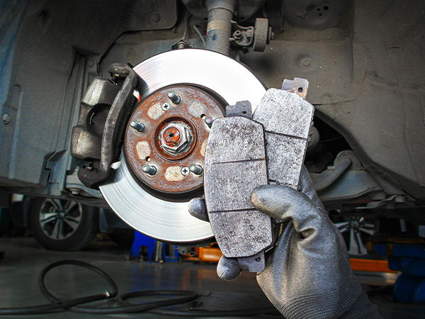 Close up of hands holding brake pads