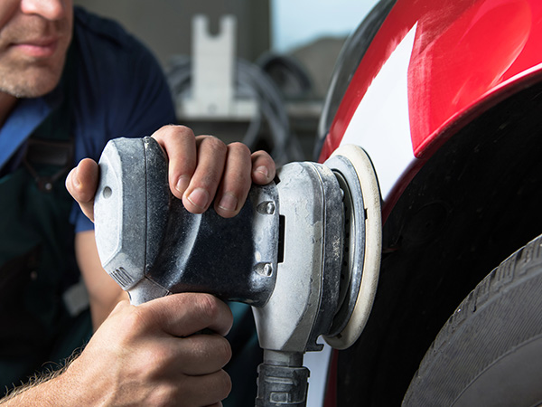 Service tech buffing out a vehicle