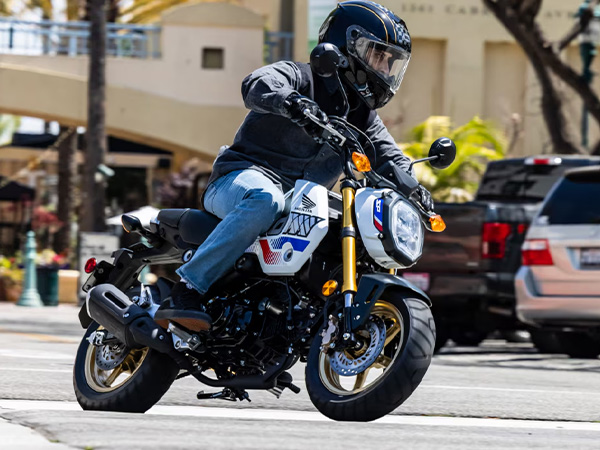 Man riding a motorcycle through the city