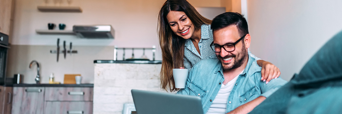 Happy couple using laptop to leave reviews