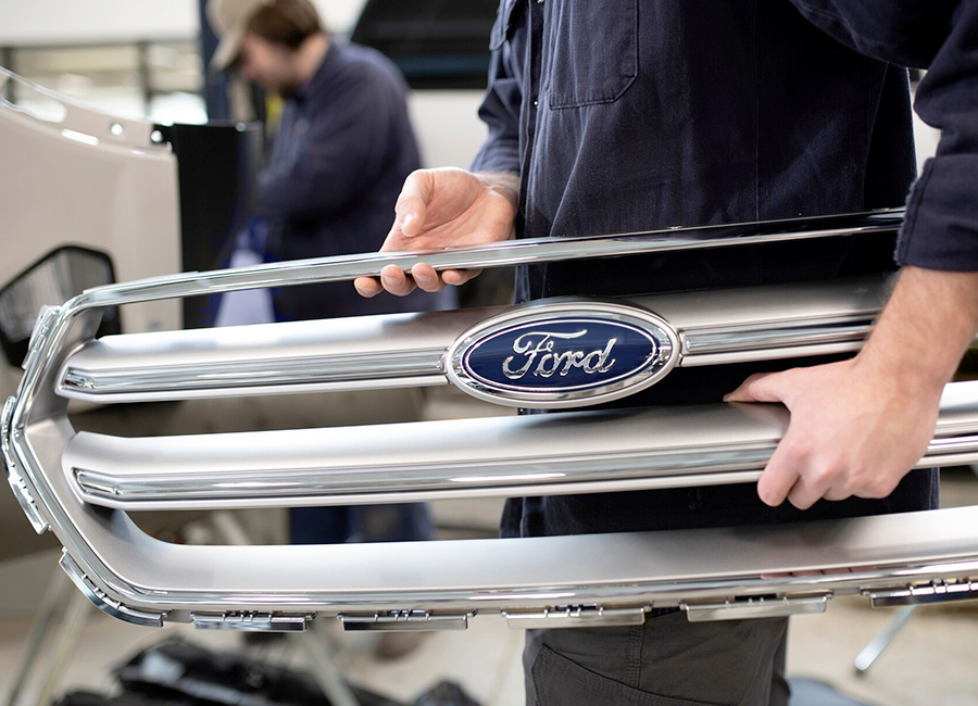 Ford technician holding a ford part