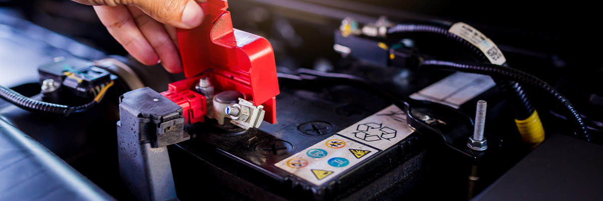 auto technician checking battery life with batt