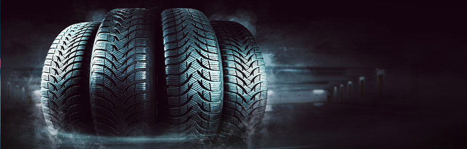 four tires next to each other with a dark background