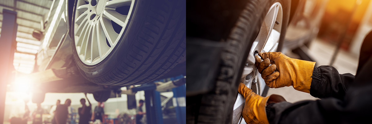 auto technician tightening wheel bolt by hand