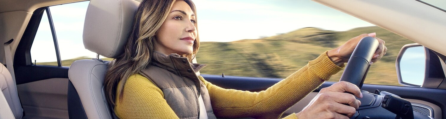 Cozy woman driving her ford