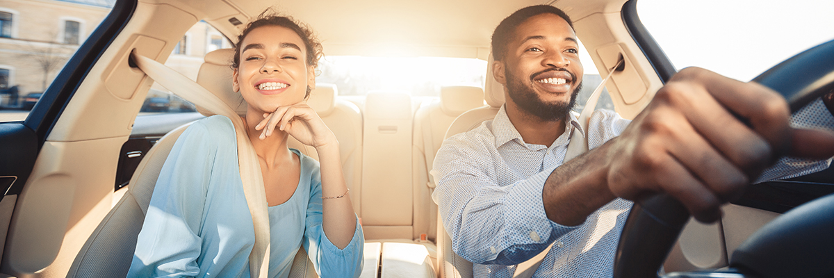 Happy couple driving in their car.