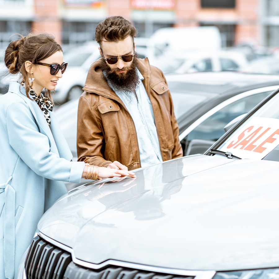 Couple looking at cars on a lot