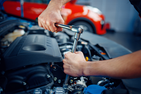 Worker disassembles vehicle engine, car service