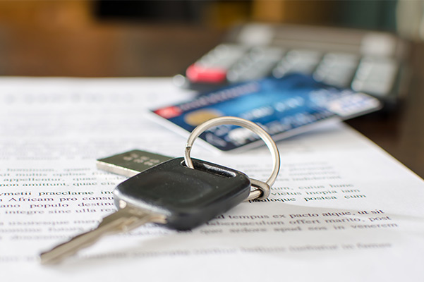 Car keys lying on paper work with credit card