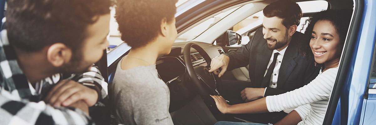 happy family shopping for a used car