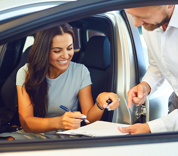 Customer signing papers for their car 